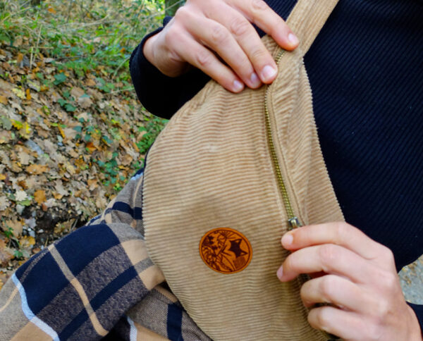 Gros plan sur notre écusson rond vanlife sur banane en velours cotelé 100% ecoresponsable