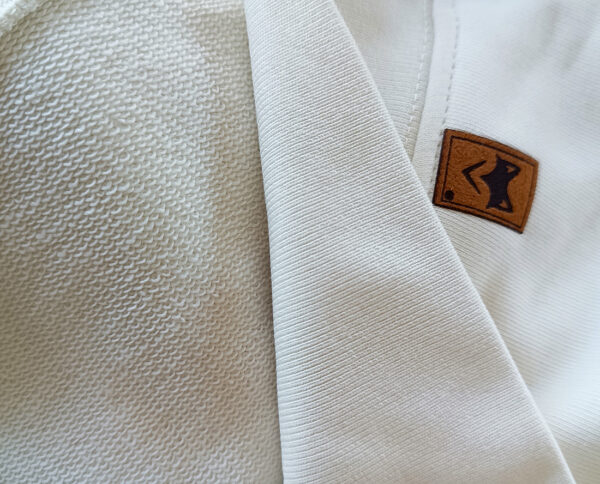 Gros plan sur tissu blanc avec étiquette textile, matière écoresponsable