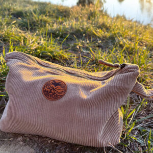 pochette maia en velours cotelé posée dans l'herbe